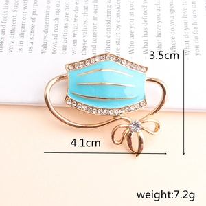 Creative blue enamel face mask brooch with gold trim and white rhinestones decoration
