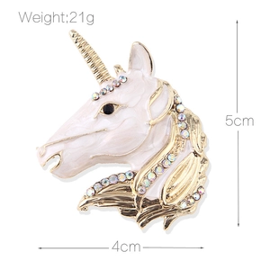 Unicorn enamel brooch with iridescent rhinestones and golden base on white background