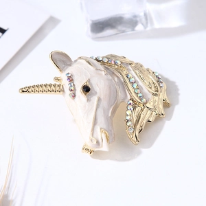 Charming unicorn enamel brooch with gold trim and colorful rhinestones on white background