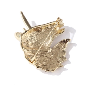 Golden unicorn head enamel brooch back view featuring security safety pin and matte texture