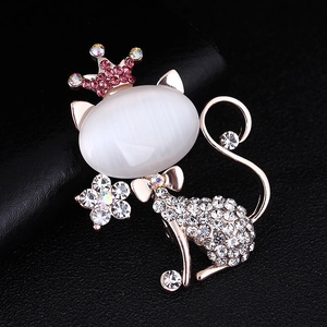 Detail of cat brooch with oval opal stone crown and pink rhinestones on black leather
