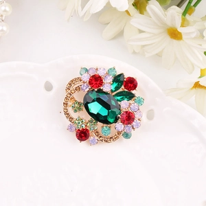 Exquisite gold floral brooch with oval green gemstone and colorful rhinestone petals