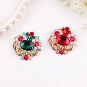Detailed view of elegant flower brooches with colorful crystals and gold-tone plating