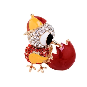 Enameled chick brooch with crystals and sun hat on a minimalist white background