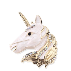 Detail of unicorn brooch with golden metal lines, white enamel and colorful rhinestones