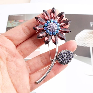 Macro view of vintage silver flower brooch with purple crystals and sparkling rhinestones