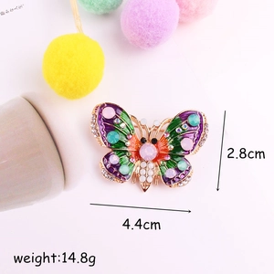 Spilla a farfalla in smalto con strass colorati su base in lega dorata