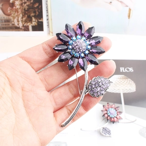 Detail of sunflower brooch with purple teardrop crystals and sparkling rhinestones