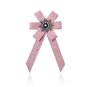 Detailed view of pink herringbone ribbon bow brooch with star rhinestone center