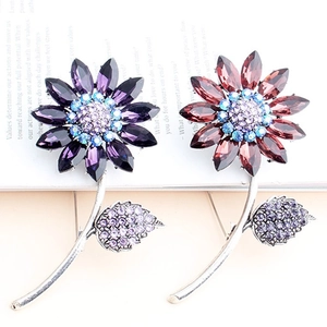 Sparkling crystal flower brooches in purple and red-brown with detailed leaf accents