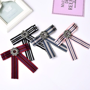 Elegant rhinestone bow brooches set in black, grey, pink and striped ribbon designs