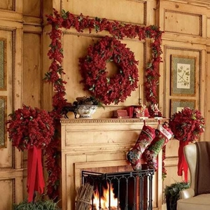 Cozy indoor scene of Christmas red berry wreaths and garlands on a rustic wooden mantel