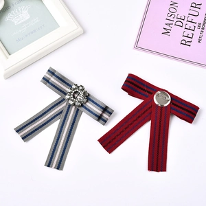 Elegant bow tie brooches in grey and burgundy stripes with crystal center and metal pin
