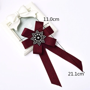 Elegant burgundy striped ribbon bow brooch featuring a sparkling snowflake rhinestone center