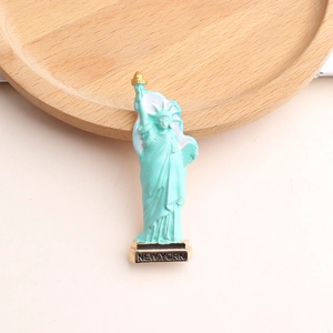 Detail view of Statue of Liberty brooch with New York text and gold torch accents