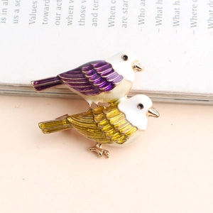 Exquisites Paar Vogel-Broschen mit buntem Emaille-Finish auf weißem Hintergrund und Magazin