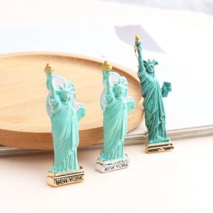 Macro detail of Statue of Liberty enamel brooches with New York engraving on the base