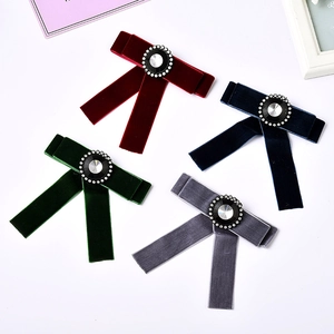Elegant velvet bow brooches in four colors featuring crystal rhinestone accents