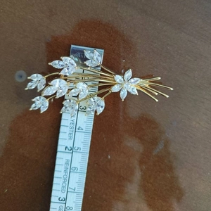 Elegant gold crystal wheat brooch with marquise-cut gems, length 8cm, on wooden surface