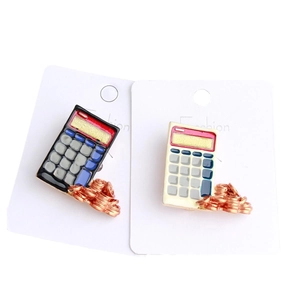 Black and white calculator enamel pins with gold coin details on fashion display cards