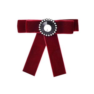 Elegant burgundy velvet bow brooch with central black gemstone and crystal detailing