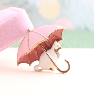 Spilla smaltata con gatto giapponese carino e ombrello rosa su portagioie di velluto