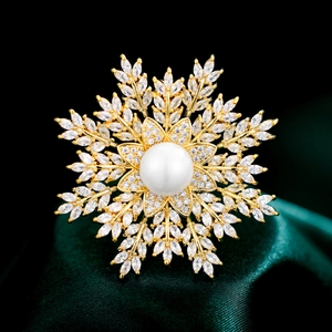 Luxury sparkling snowflake brooch with white pearl and zircons on green silk background