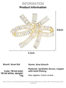 Detailed spec view of a gold bow brooch with zircon inlay, size 5.5cm by 4.6cm