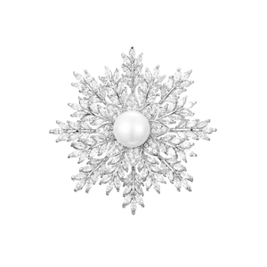 Detail of luxury snowflake brooch with sparkling cubic zirconia and a large white pearl