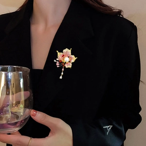 Elegant floral brooch with pink zircons and pearl drop tassel on black suit