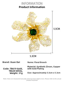 Detailed view of luxury flower brooch with cubic zirconia and green center gemstone