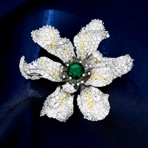 Macro detail of a 3D floral brooch with green zircon and sparkling paved stones