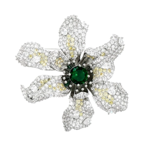 Detail shot of 3D flower brooch with green center stone and cubic zirconia crystals