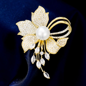 Macro detail of floral brooch with white pearl, zircon stones and tassel crystal drops