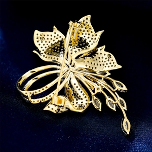 Macro detail of gold flower brooch back with honeycomb base and safety pin closure
