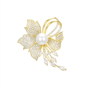 Elegant gold flower brooch with zircon stones, a white pearl and tassel drop