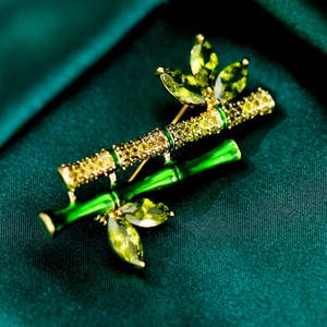 Detail of bamboo brooch with green enamel, micro-pave crystals and golden finish