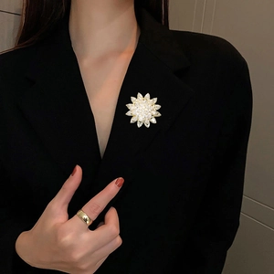 Sparkling triple-layer snow lotus zircon brooch pinned on a black suit blazer