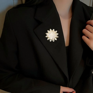 Close-up of sparkling floral zircon brooch pinned on a stylish black blazer lapel