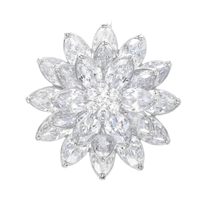 Macro detail of multi-layer lotus brooch featuring marquise-cut white zircons and silver plating