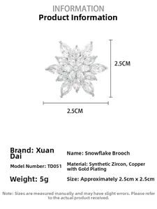 Macro detail of snowflake brooch with synthetic zirconia and gold-plated copper finish