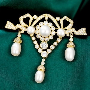 Detailed close-up of a luxury vintage golden brooch with pearls and tassels