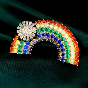 Luxurious sun and rainbow brooch with colorful gemstones on a gold-plated alloy base