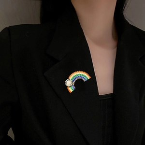 Elegant rainbow rhinestone brooch pinned on black blazer for women fashion style