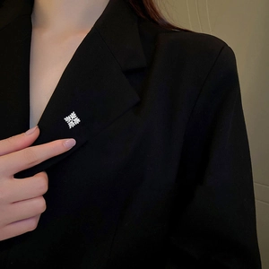 Elegant silver snowflake brooch with zircons on a black blazer lapel for women and men