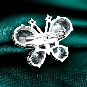 Macro view of butterfly brooch pin back with silver metal and transparent crystals