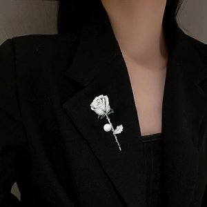 Elegant rose brooch with pavé zircon and pearl on black blazer lapel for women