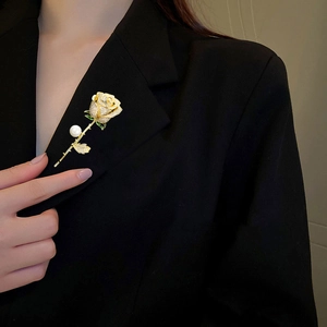 Detailed view of elegant rose brooch with white pearls and crystals on a black suit lapel