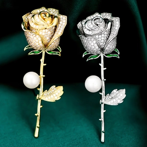 Macro detail of elegant rose brooch with pavé zircon petals and premium white pearl