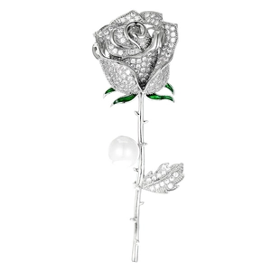 Detail of elegant silver rose brooch with sparkling zircons and a white pearl accent
